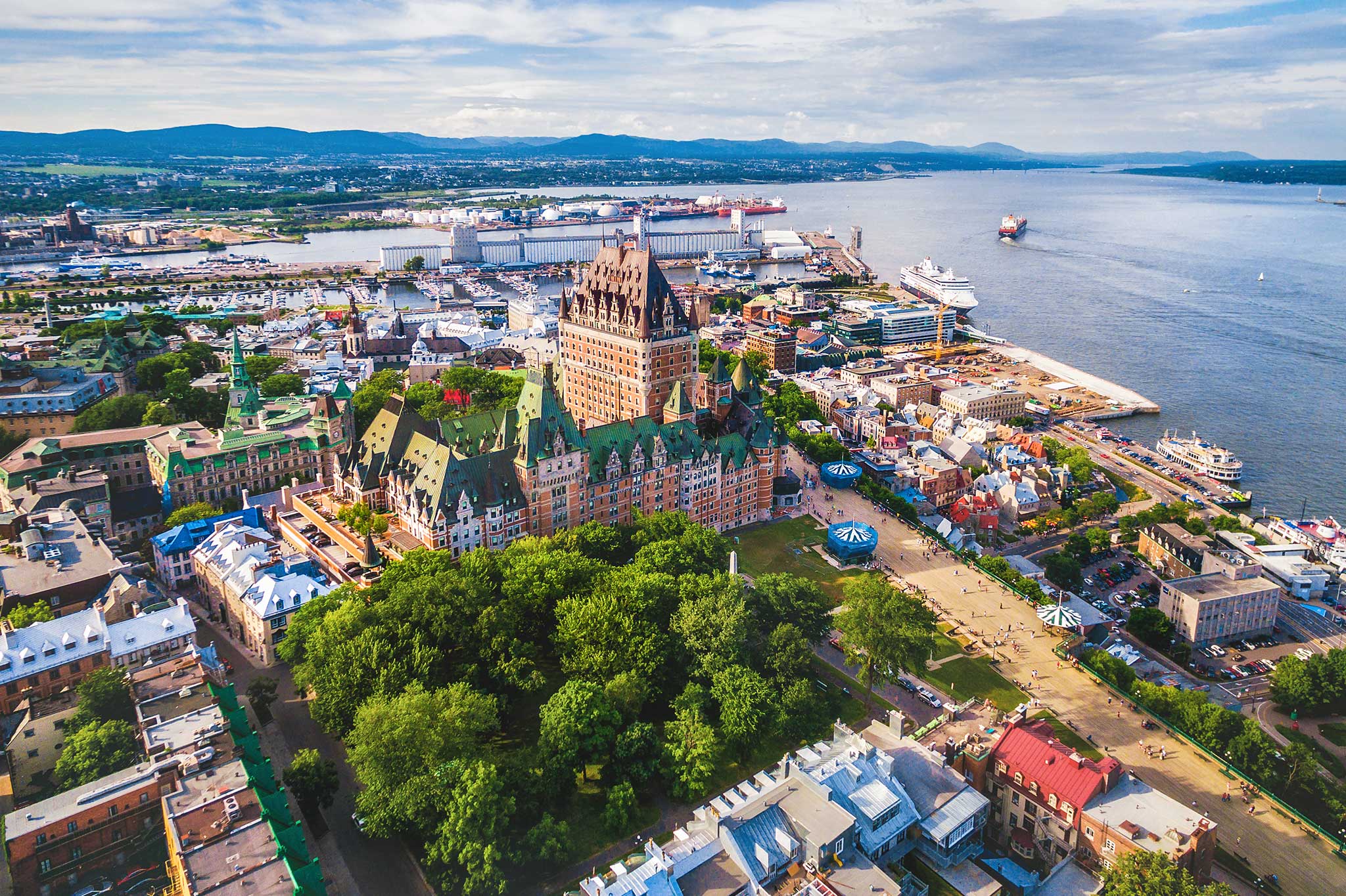Aerial view of Quebec City featuring Chateau Frontenac, Old Port and the St. Lawrence River.