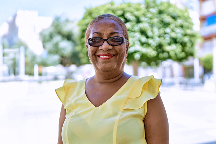 Smiling woman wearing a yellow top