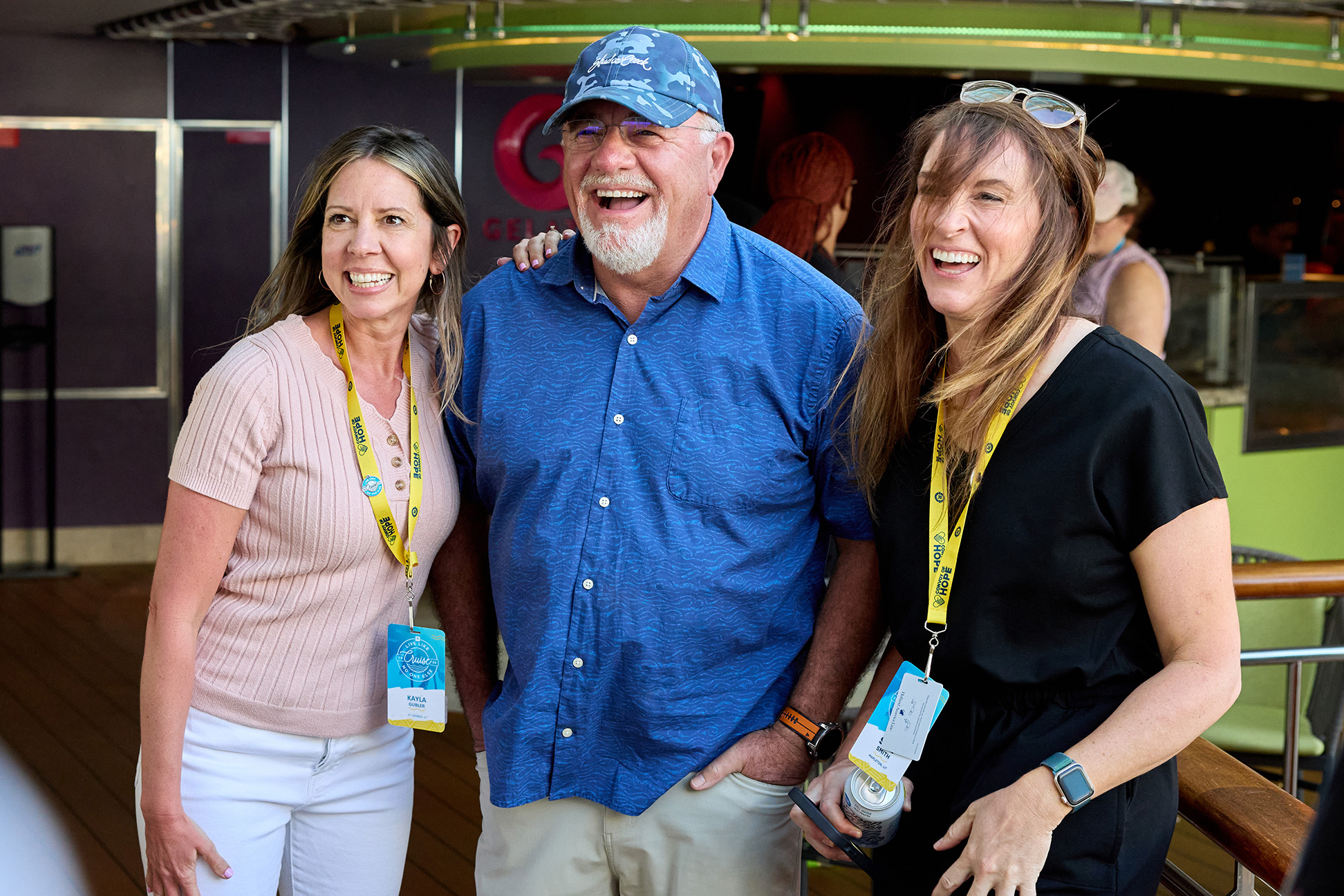 Dave Ramsey smiling for a picture with cruise passengers