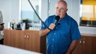 Dave Ramsey holding a microphone
