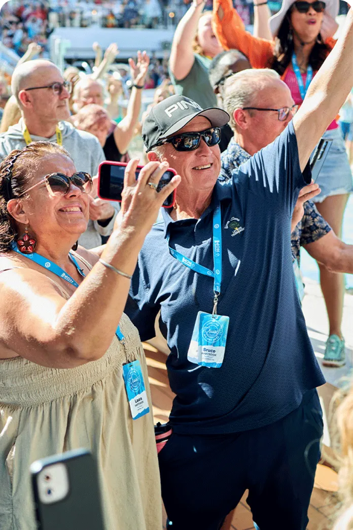 Smiling group of travelers waving and taking pictures