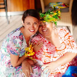 Two smiling woman wearing colorful shirts